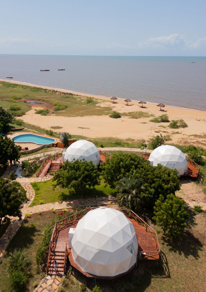 A stone path through the garden between the dome tents