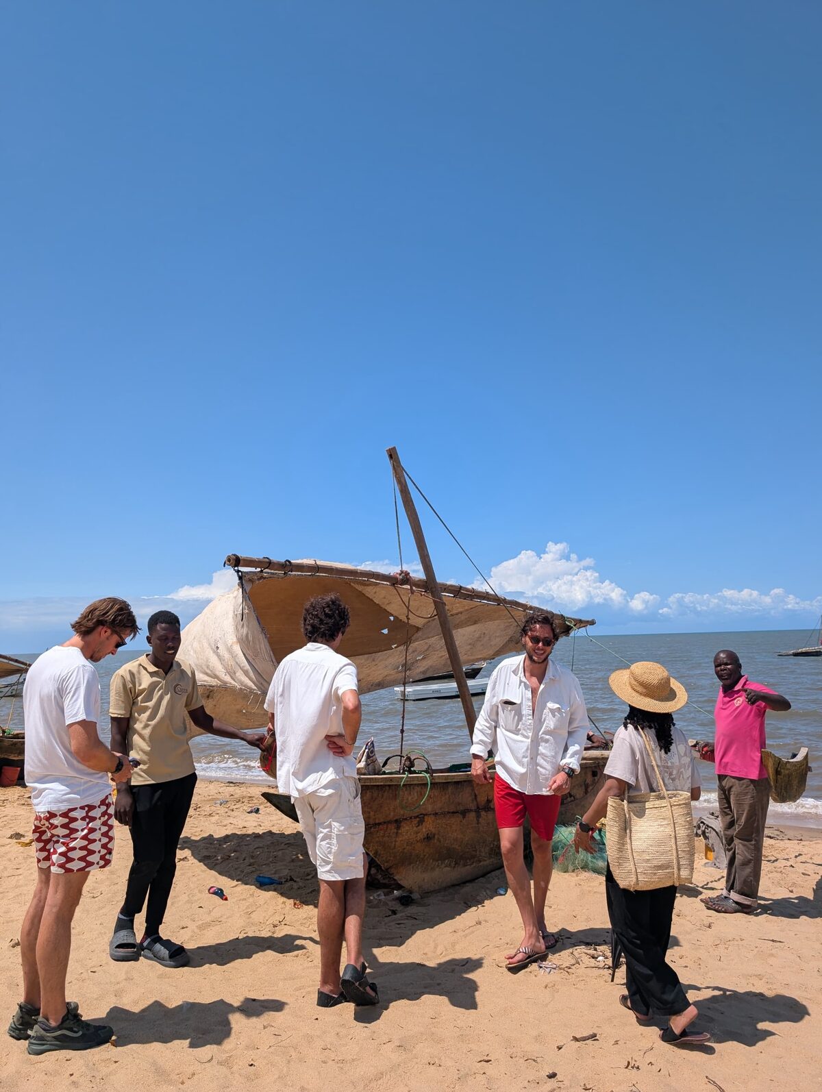 Guests and the Cterra crew beside a dhow before setting out