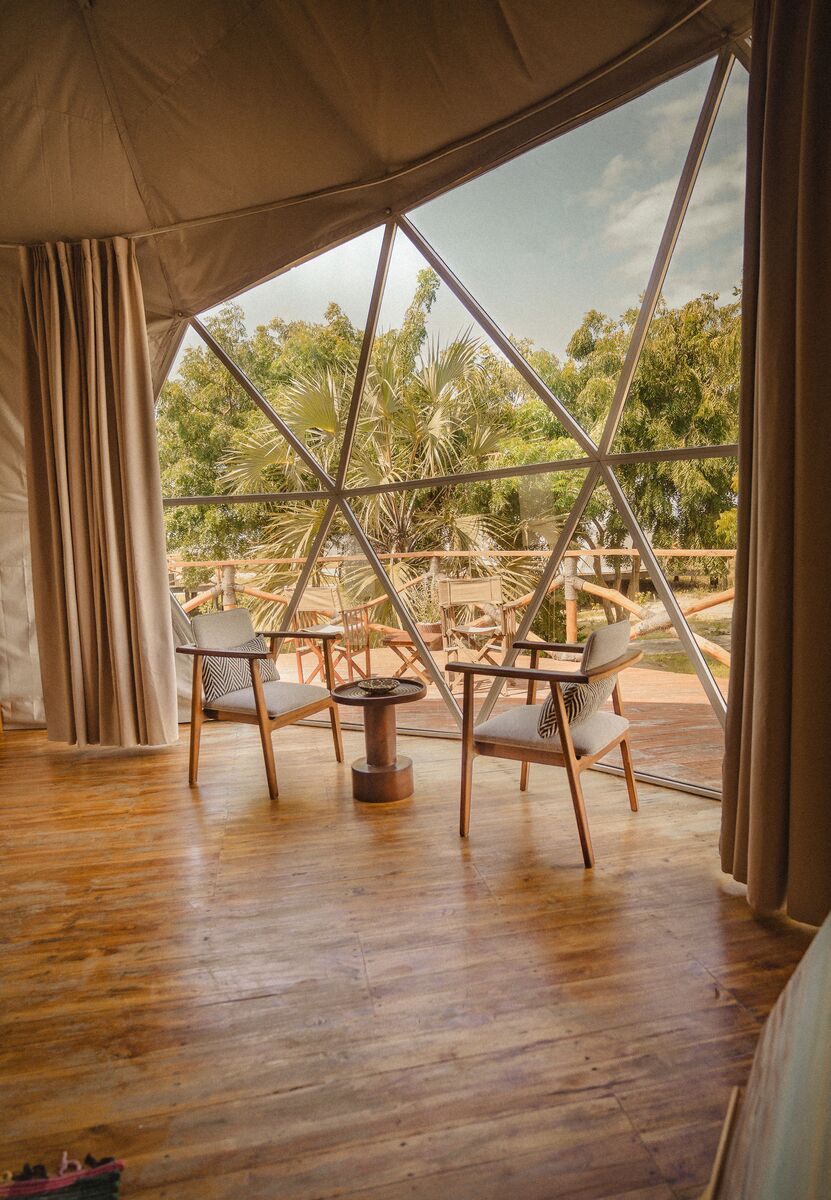 Inside a dome — Beds, headboards and the wood-and-canvas interiors of the domes, tent by tent.