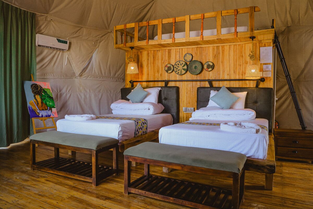 Inside a dome — Beds, headboards and the wood-and-canvas interiors of the domes, tent by tent.