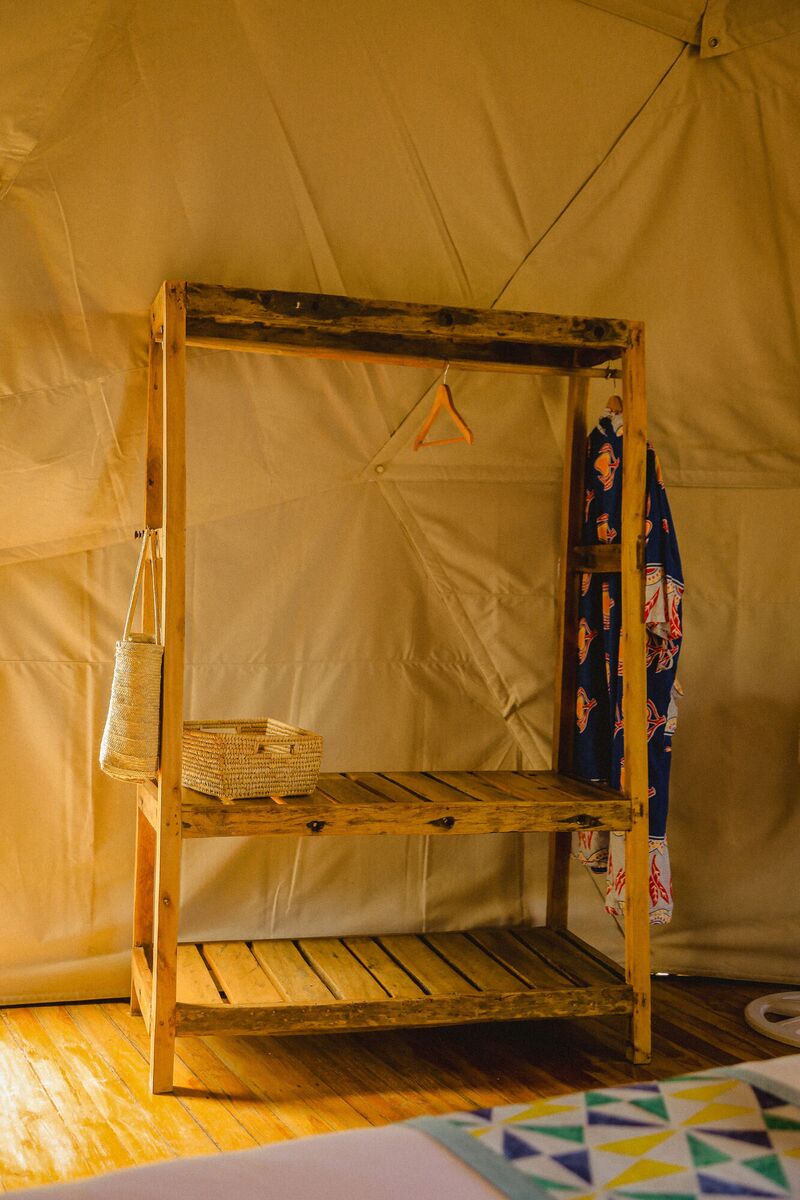 Inside a Family Garden dome at Cterra Saadani, made up as a double, with the ladder to the loft