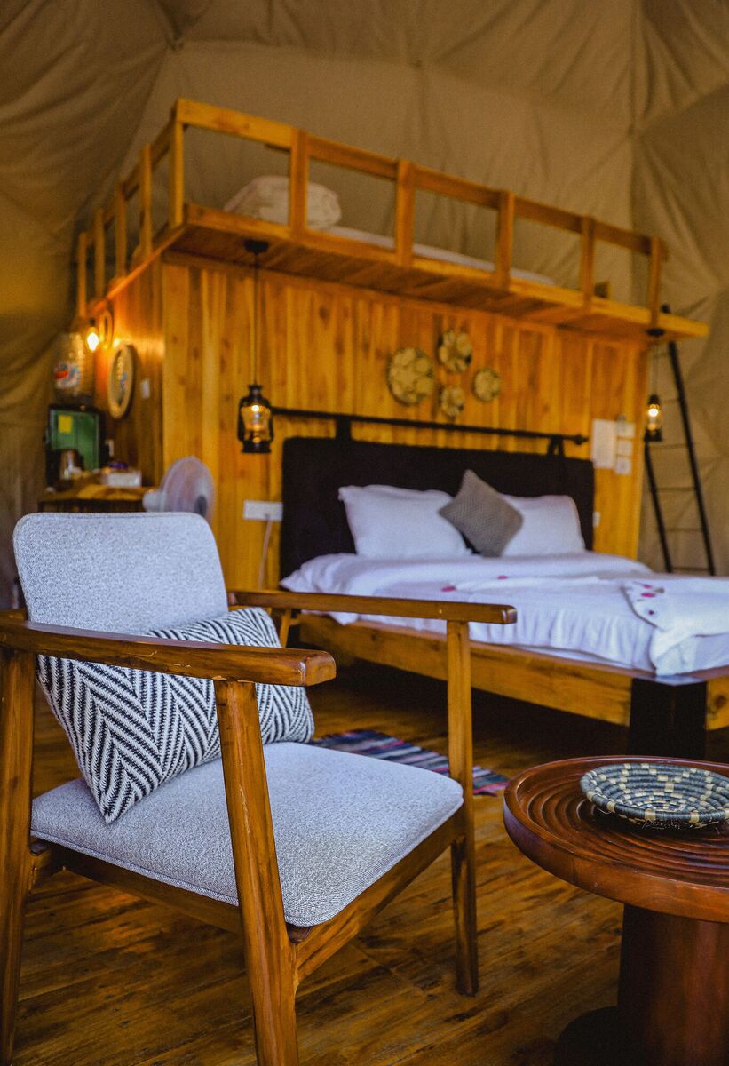 Inside a Family Garden dome at Cterra Saadani, made up as a double, with the ladder to the loft