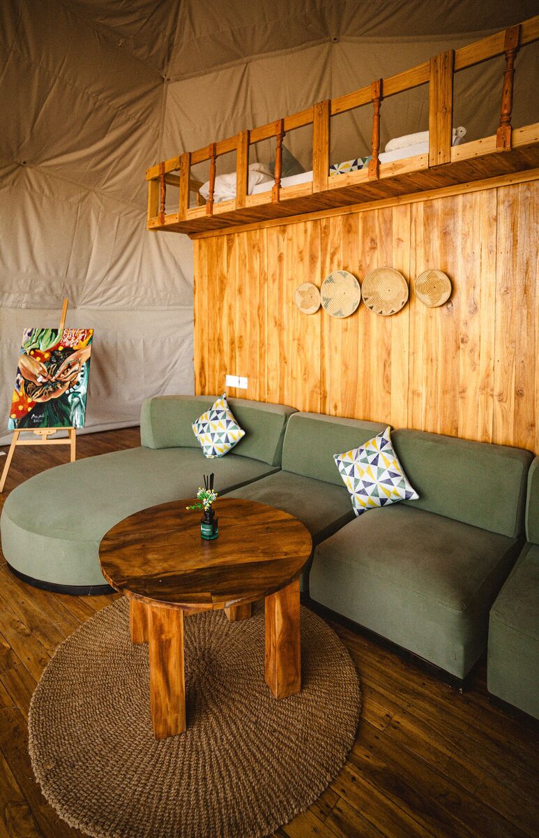 The Honey Suite at Cterra Saadani, with the green sofa and the freestanding bath