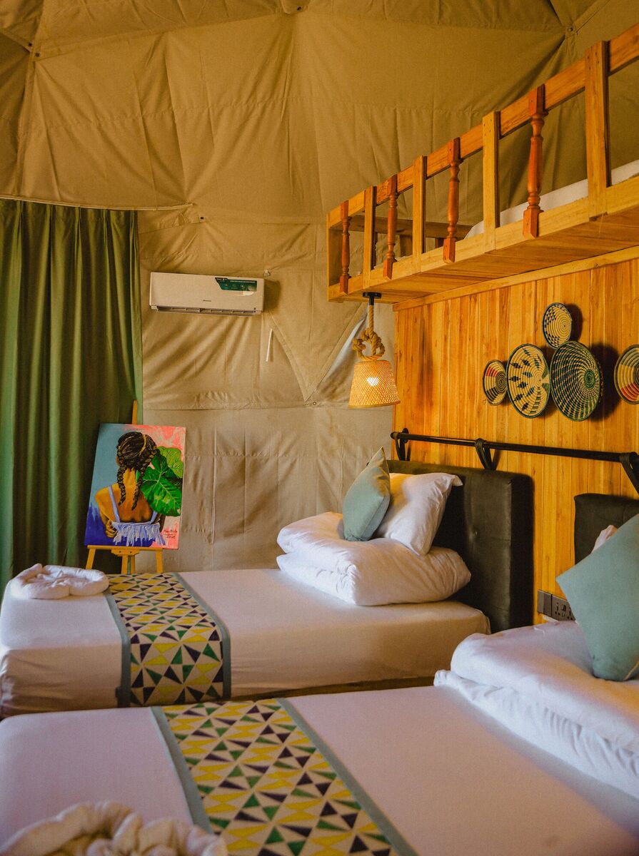 Inside the Twin dome at Cterra Saadani, with the separate beds and the woven plates on the timber wall