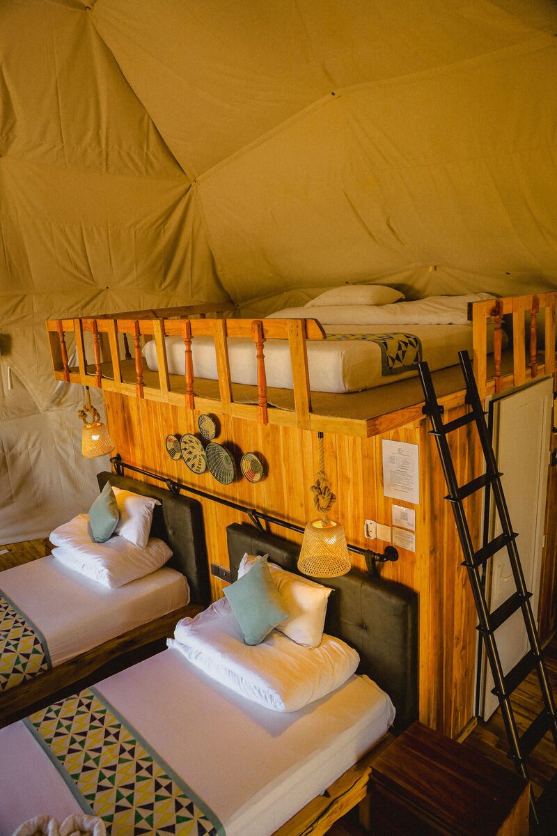 Inside the Twin dome at Cterra Saadani, with the separate beds and the woven plates on the timber wall