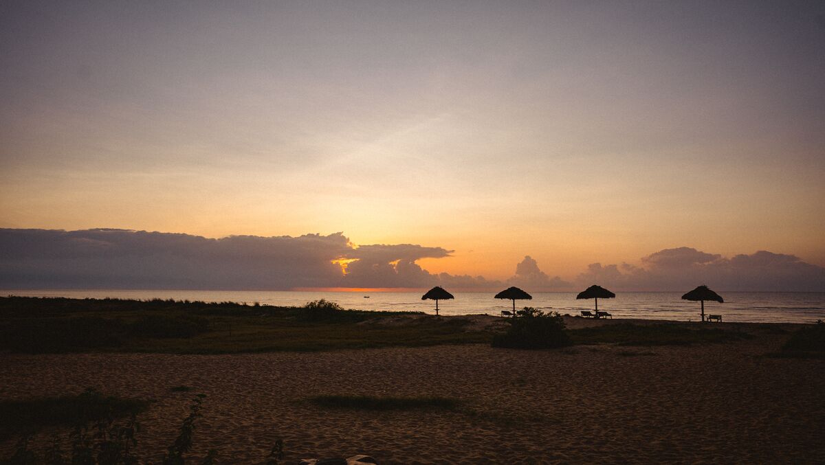 The pool at dusk, the ocean going flat behind it