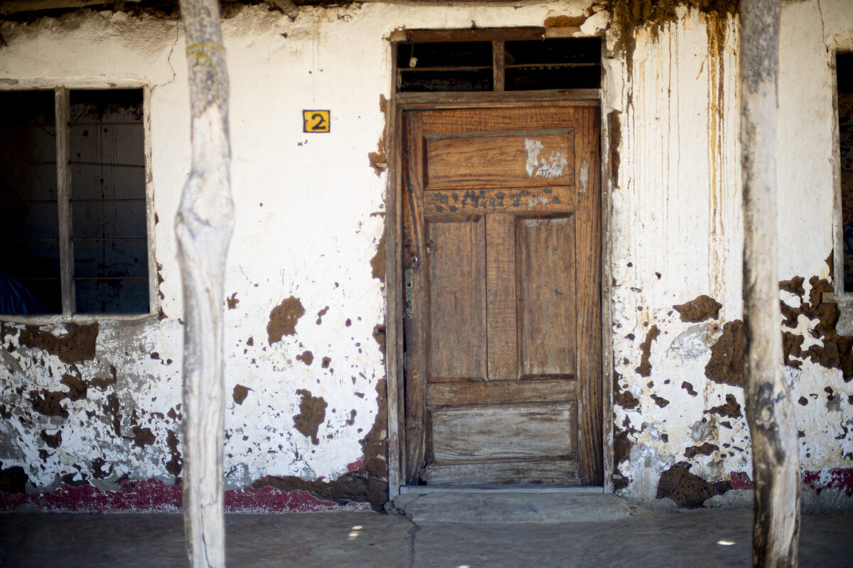 The village and the coast — Buyuni next door, a Swahili door, and a dhow on the sand at low tide.