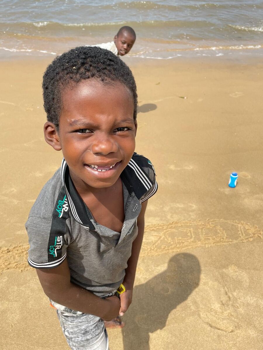 The village and the coast — Buyuni next door, a Swahili door, and a dhow on the sand at low tide.
