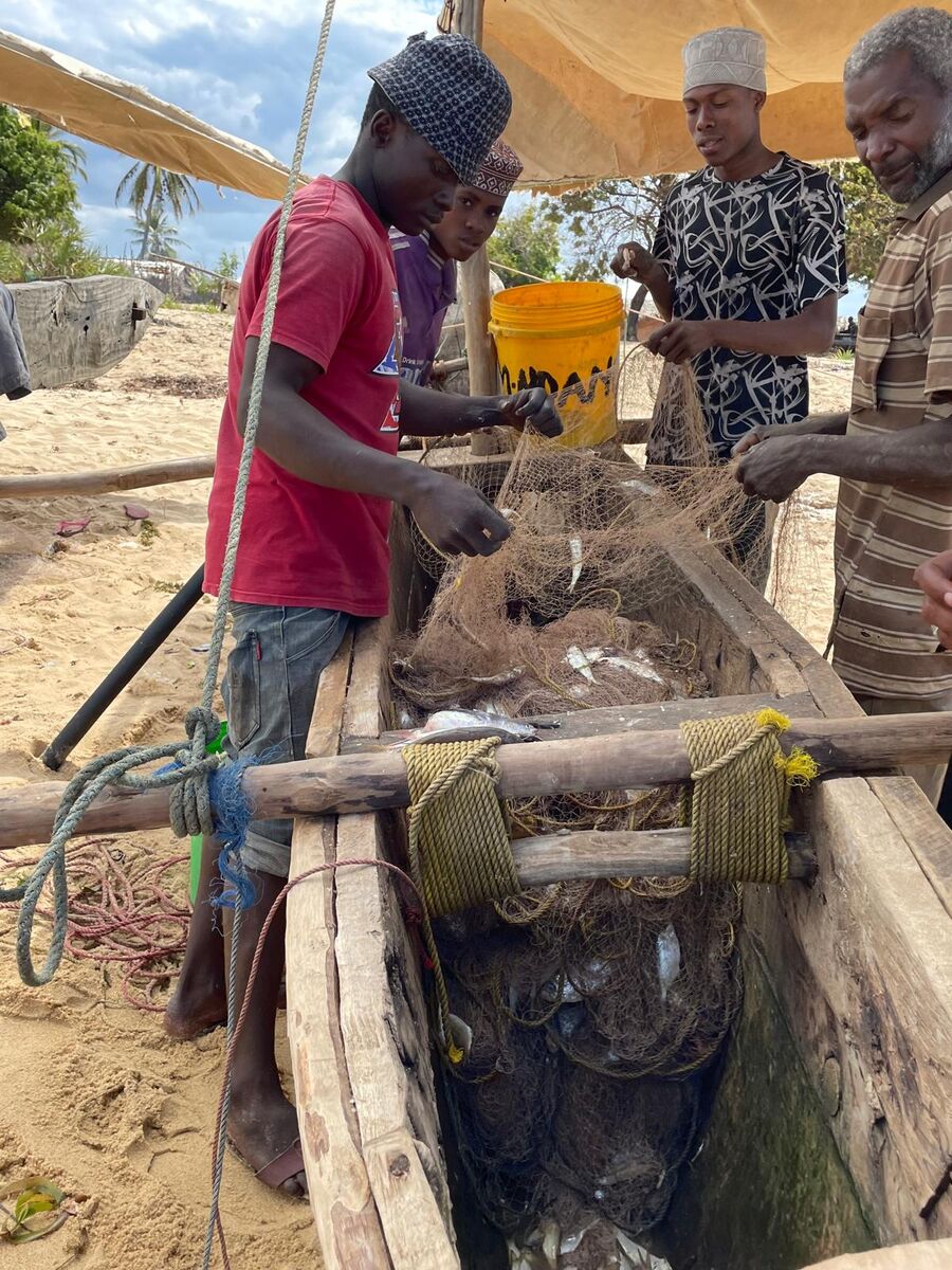The village and the coast — Buyuni next door, a Swahili door, and a dhow on the sand at low tide.