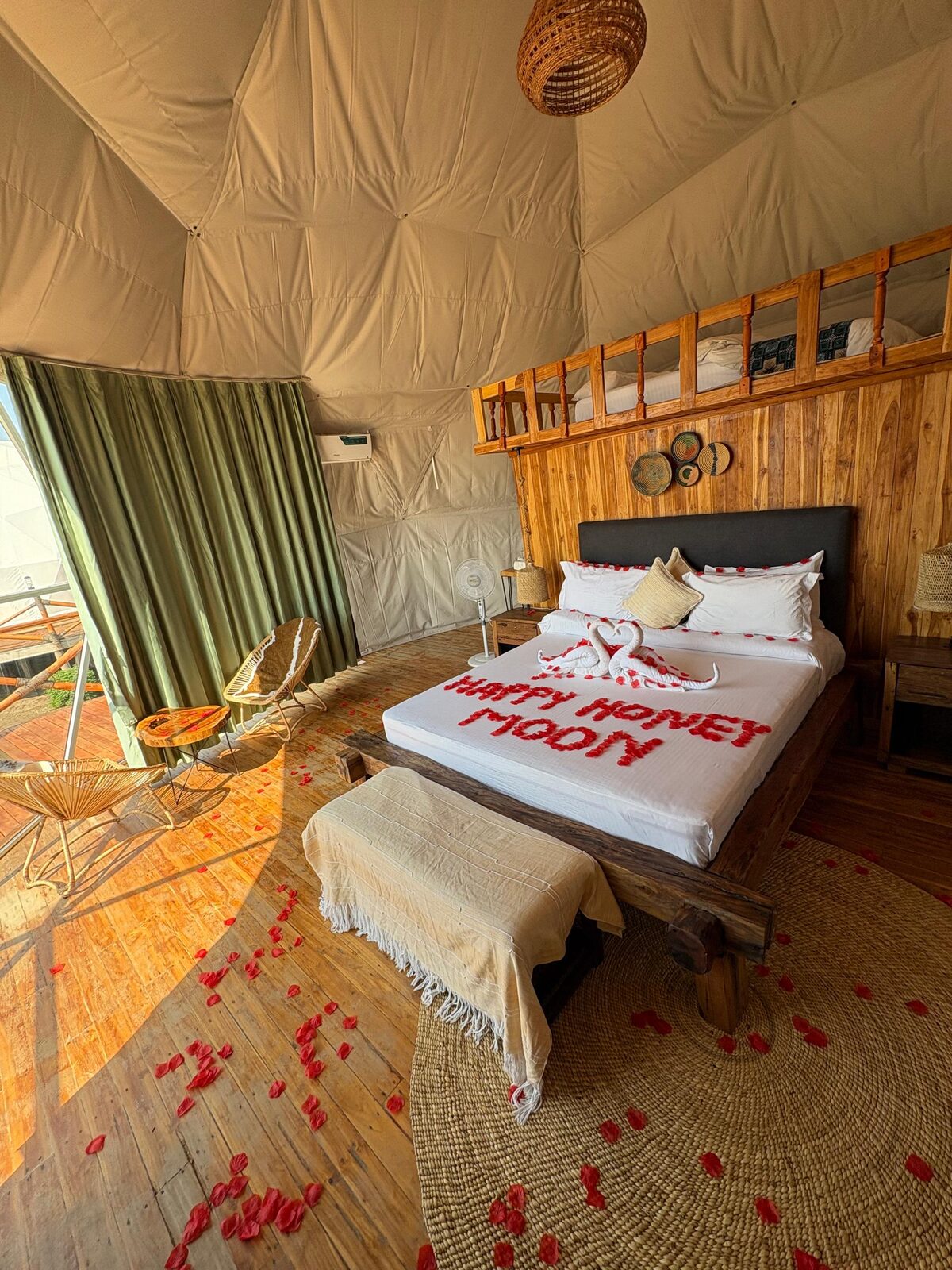 The dome tent dressed for a honeymoon, rose petals across the floor