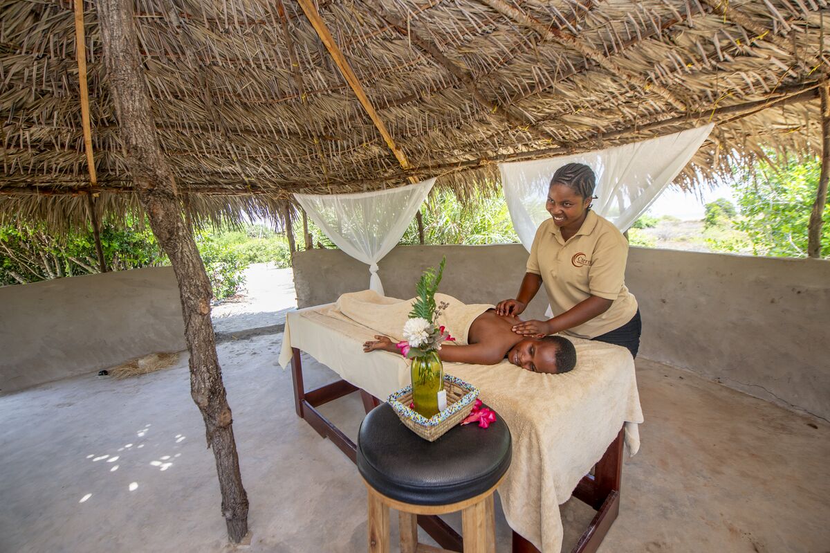 A massage under the makuti roof of the spa banda