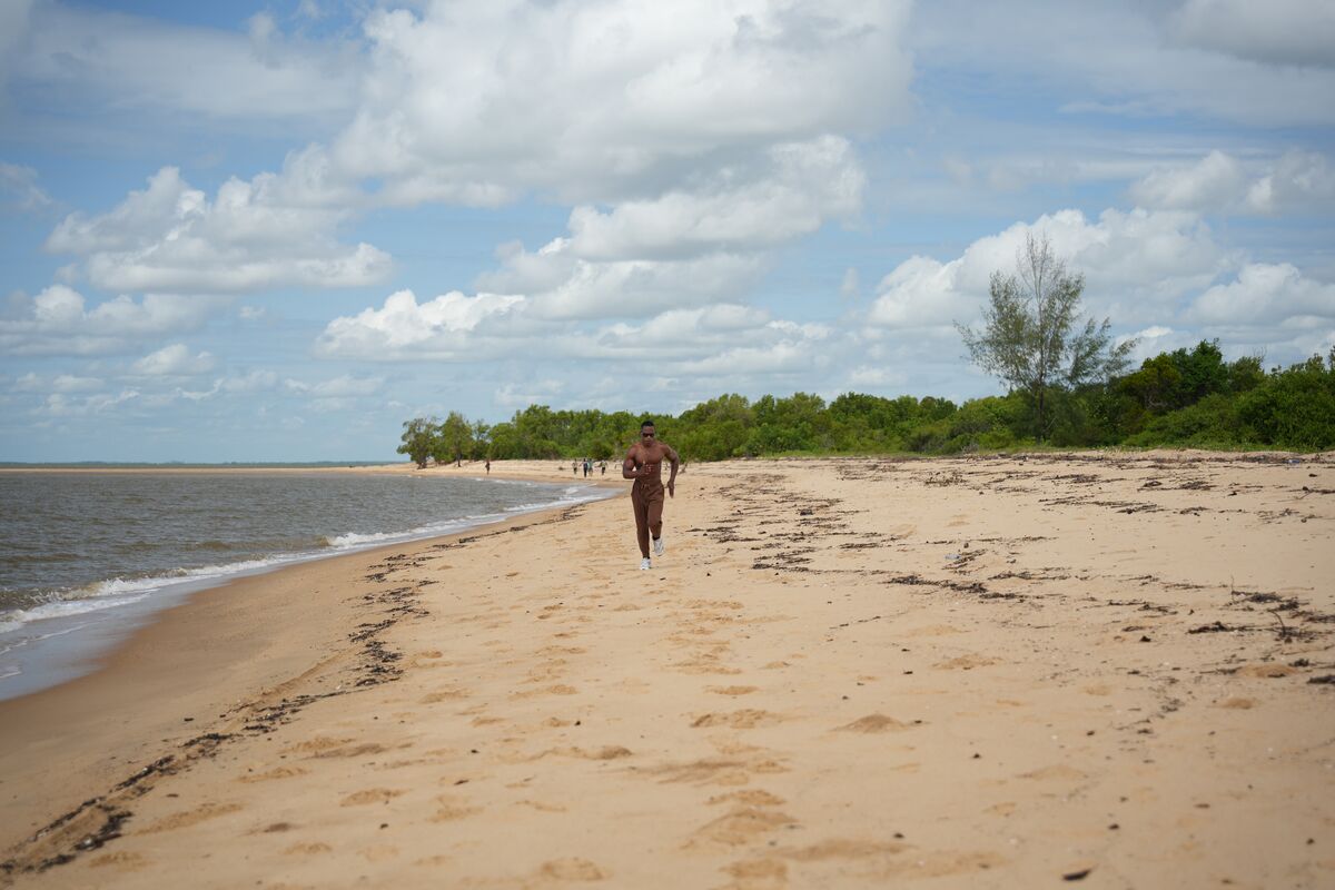 Two figures walking the empty beach