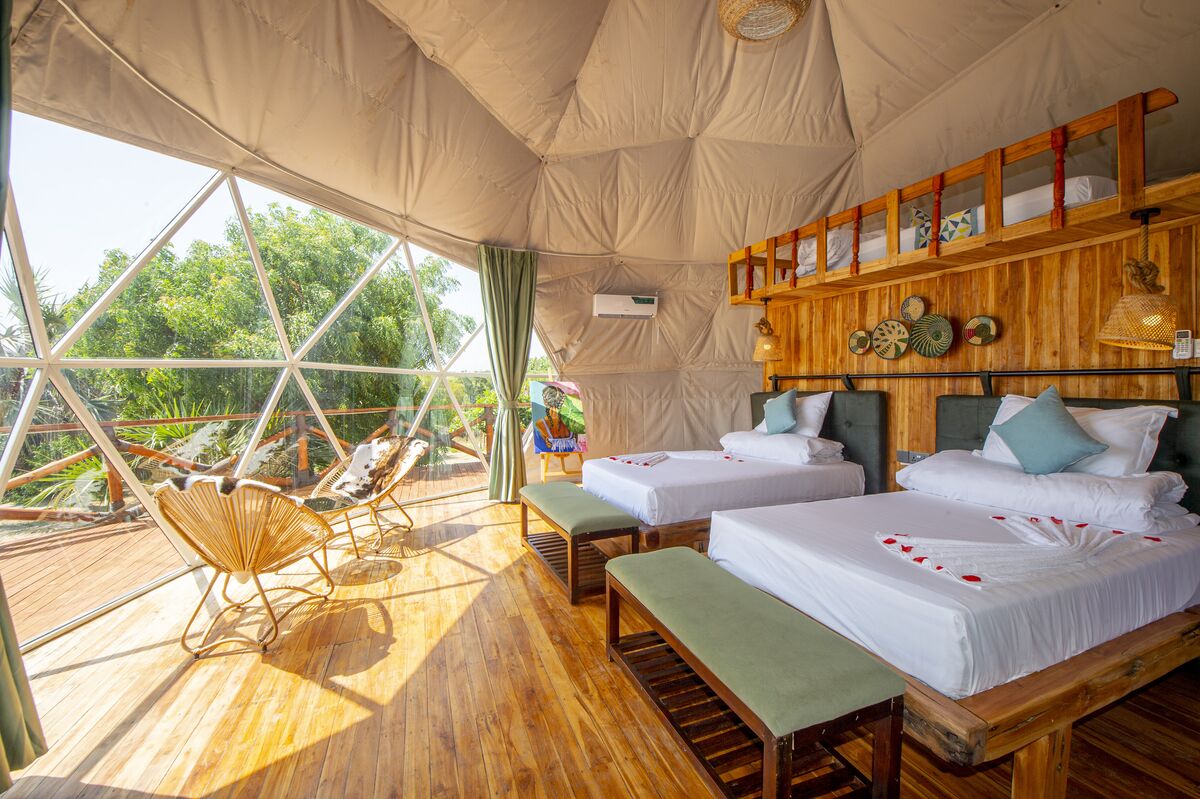 The Twin Tent at Cterra Saadani, with separate beds and the garden beyond